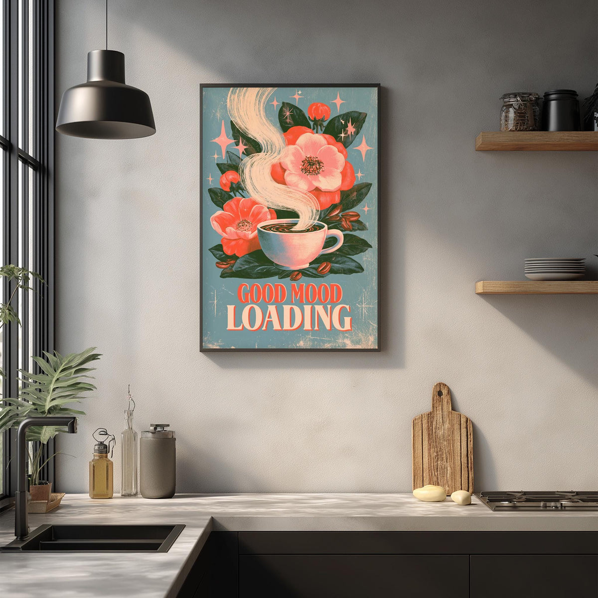 a kitchen counter with various items, including a coffee mug, a wooden cutting board, and a potted plant. Above the counter, there is a framed poster with a floral design and the text "GOOD MOOD LOADING".