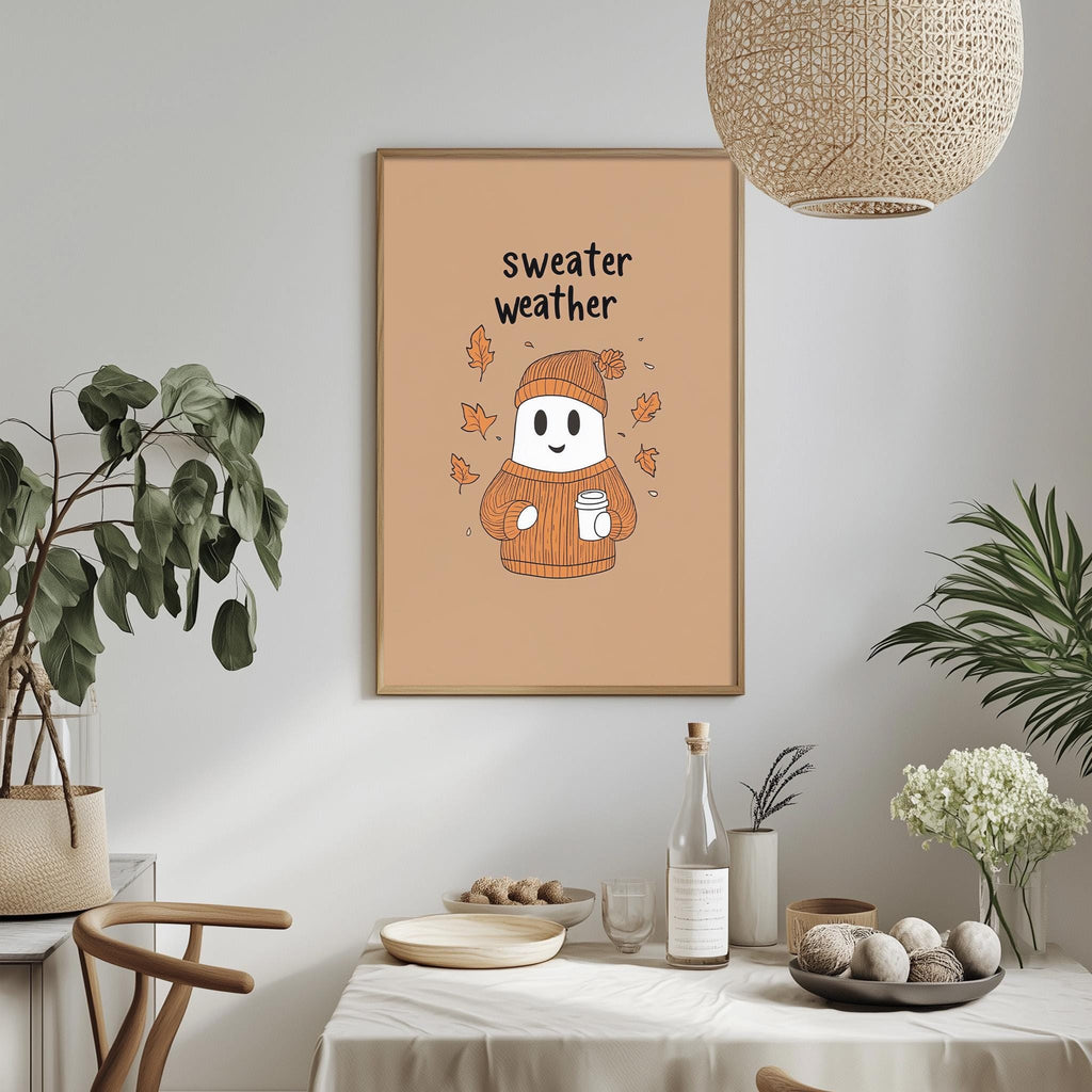 a cozy dining area with a table set for a meal, a potted plant, and a framed poster with a ghost wearing a sweater and holding a cup.