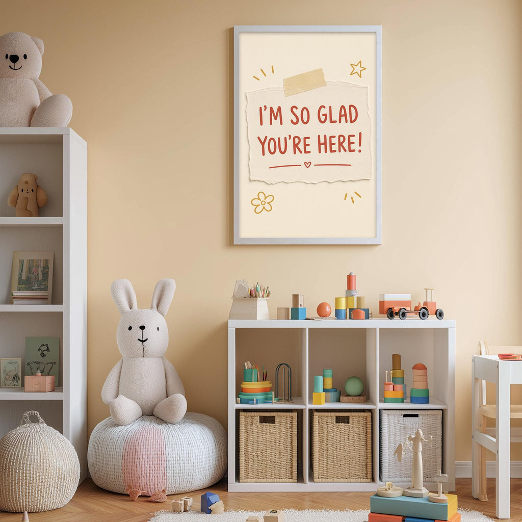 A cozy children's room with a white bookshelf, a stuffed rabbit, and a toy train. Above the bookshelf, there is a framed sign that says "I'm so Glad You're Here!"