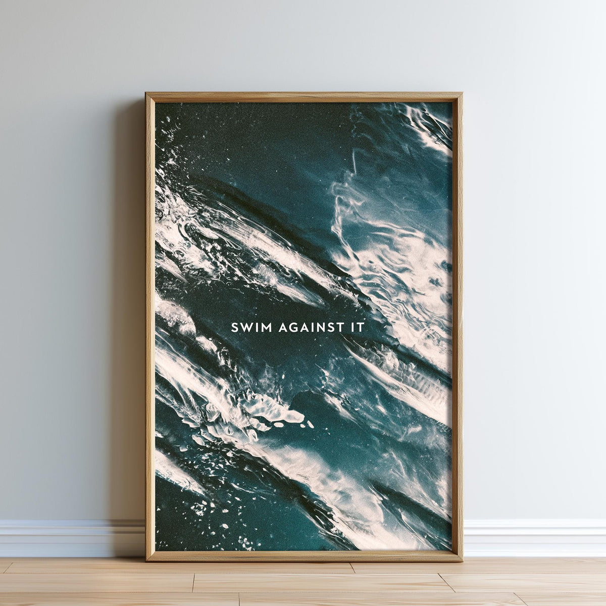 The image is a framed poster with a text overlay that reads "SWIM AGAINST IT".