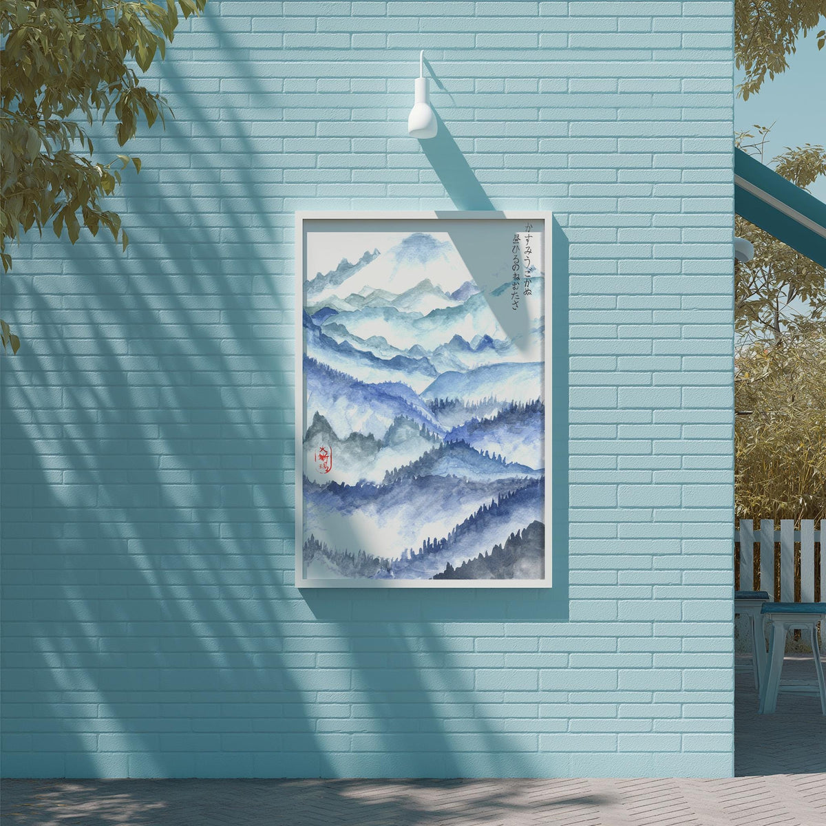 a blue brick wall with a framed painting of a mountain landscape hanging on it.