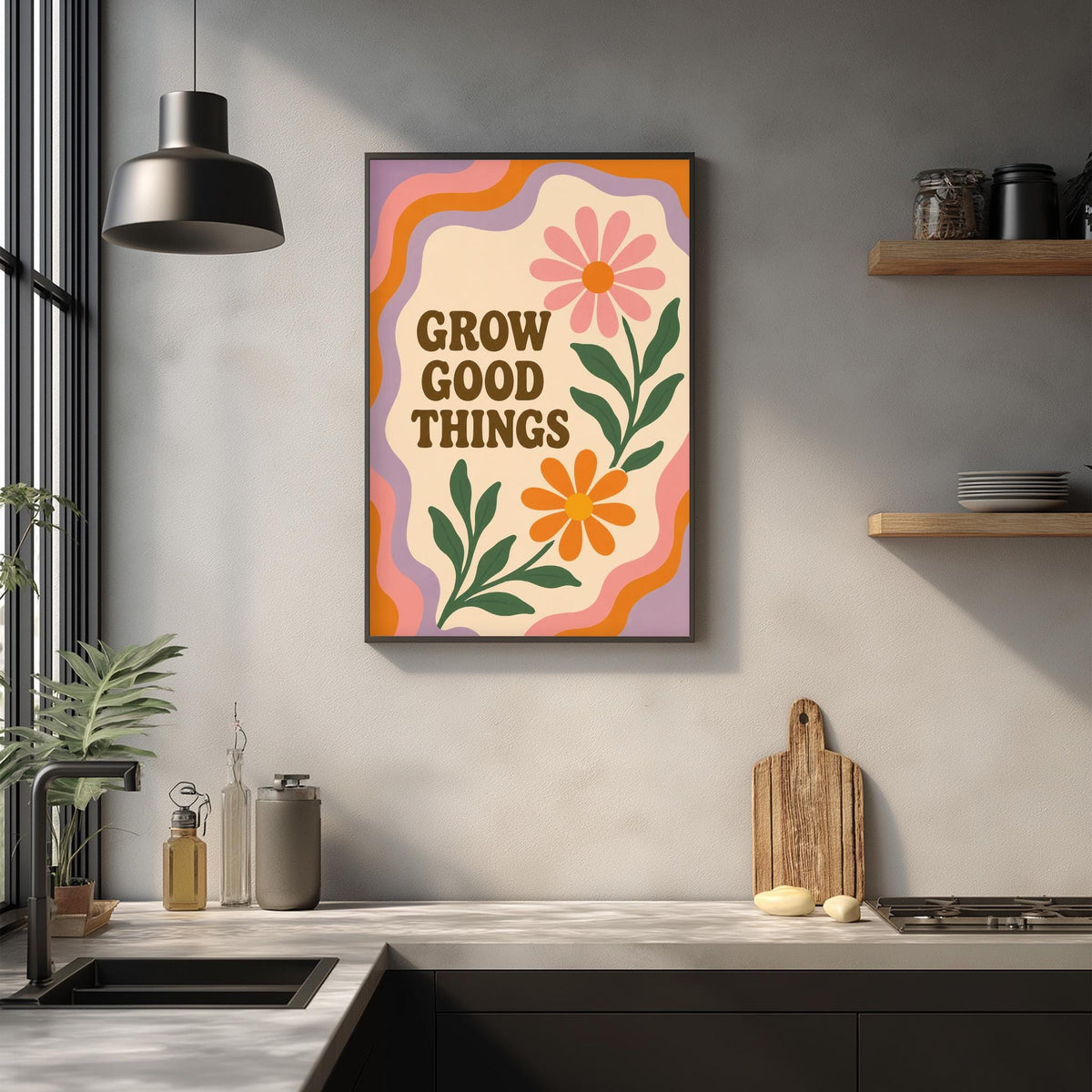 a kitchen counter with a framed poster that reads "GROW GOOD THINGS" above it. The poster has a colorful design with flowers and leaves. The kitchen counter also has various items such as a cutting board, a soap dispenser, and a plant.