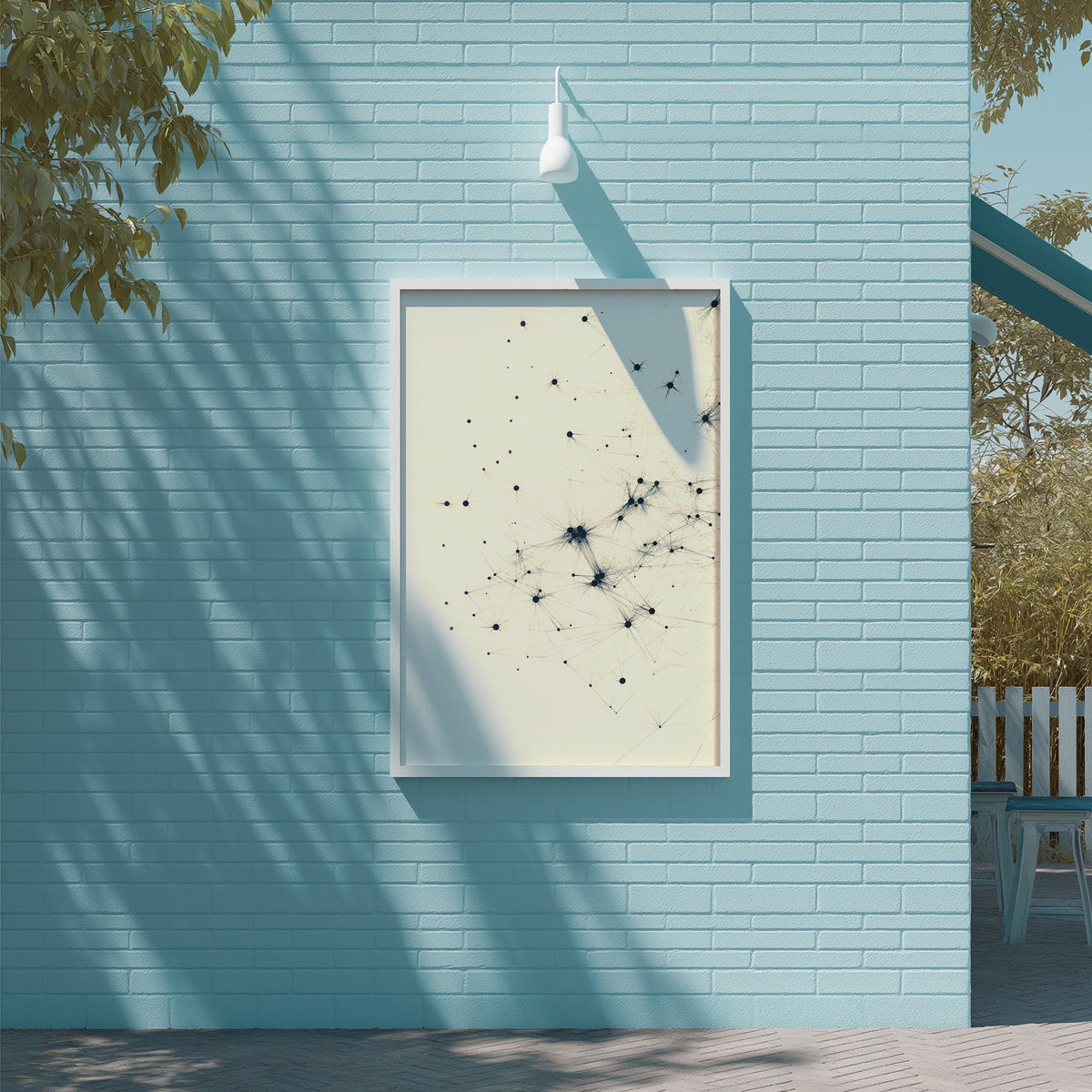 a blue brick wall with a white frame containing a black and white abstract artwork.