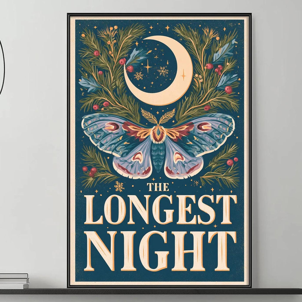 a large framed poster with a butterfly and a crescent moon on it, hanging on a wall above a gray couch with a coffee table in front of it.