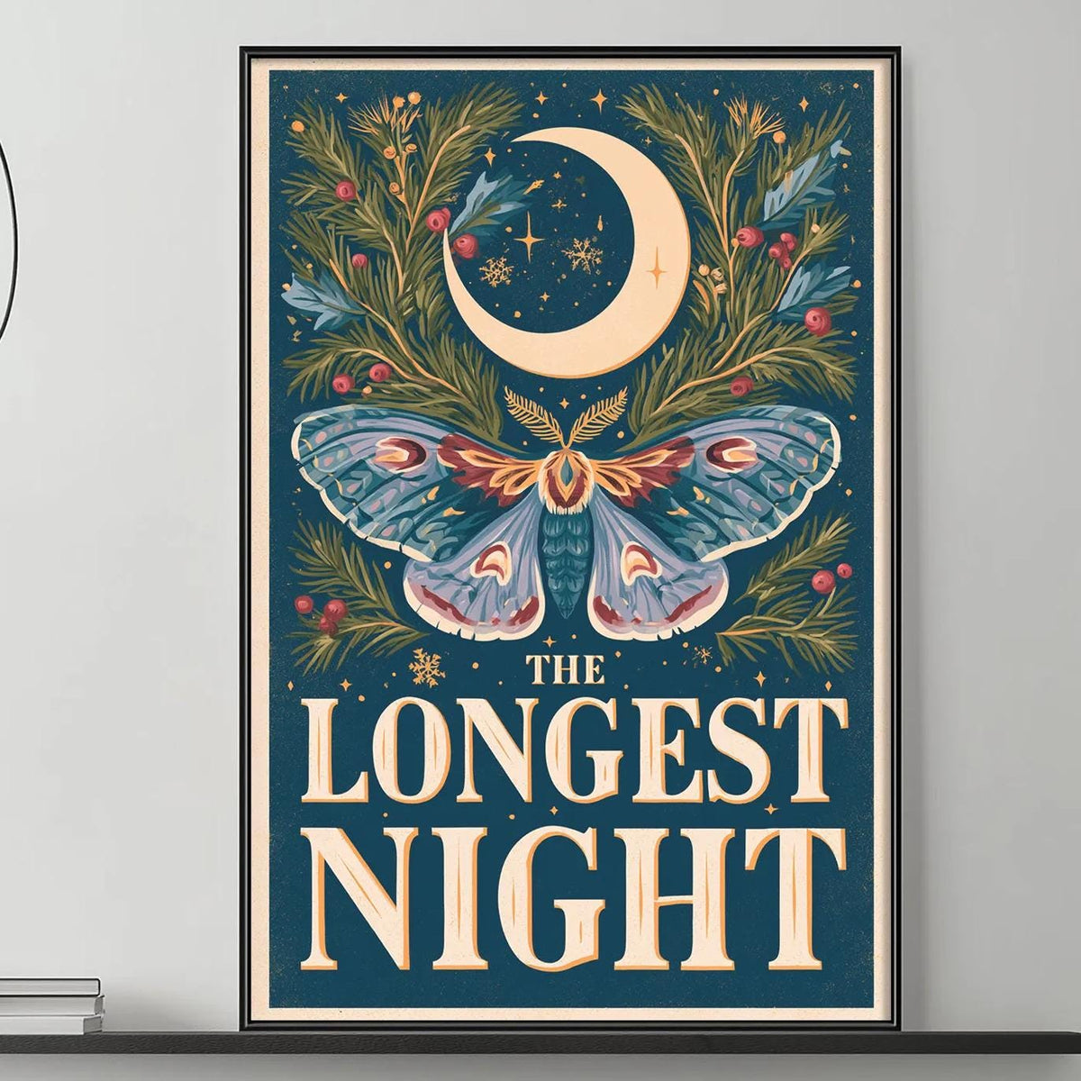 a large framed poster with a butterfly and a crescent moon on it, hanging on a wall above a gray couch with a coffee table in front of it.