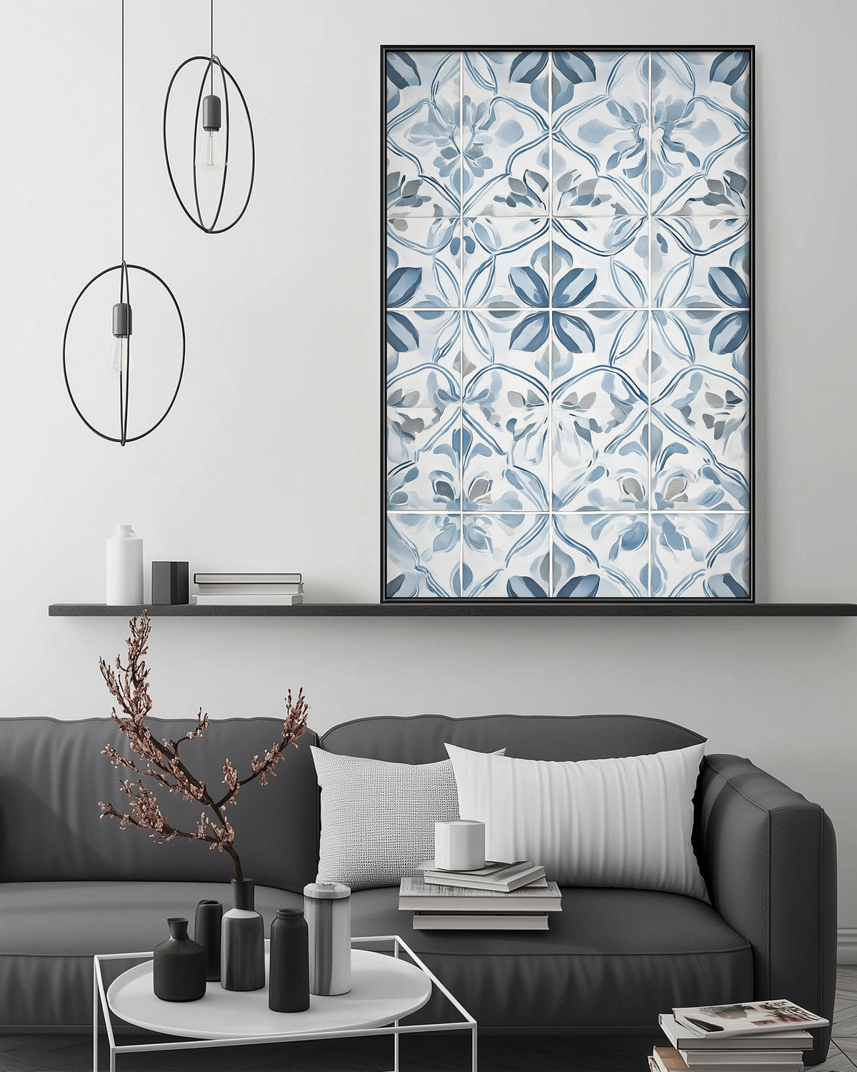 a modern living room with a gray sofa, a coffee table, and a large blue and white tile artwork hanging on the wall above the sofa.