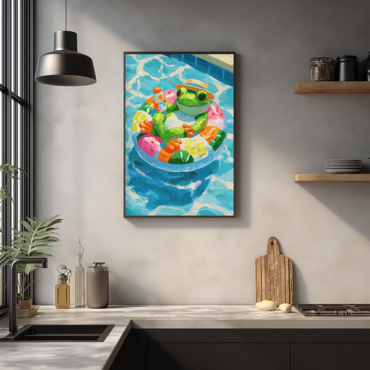 a kitchen counter with various kitchen items, including a wooden cutting board, a sink, and a potted plant. Above the counter, there is a framed painting of a frog sitting in a pool, surrounded by colorful fruits.