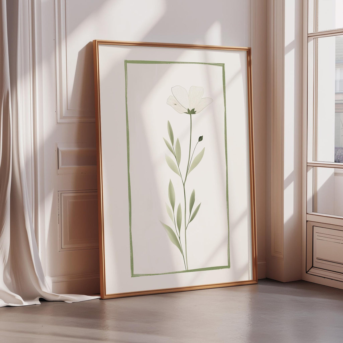 A framed print of a white flower with green leaves is displayed on a wall in a room with a window.