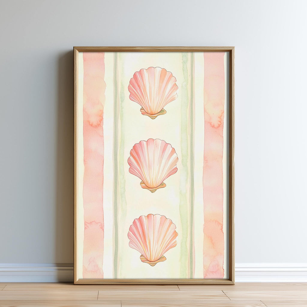A framed print featuring three pink seashells arranged in a vertical line on a light green background.