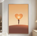 a cozy living room with a white sofa, a wooden side table, and a framed artwork featuring a silhouette of a person holding a heart-shaped object.