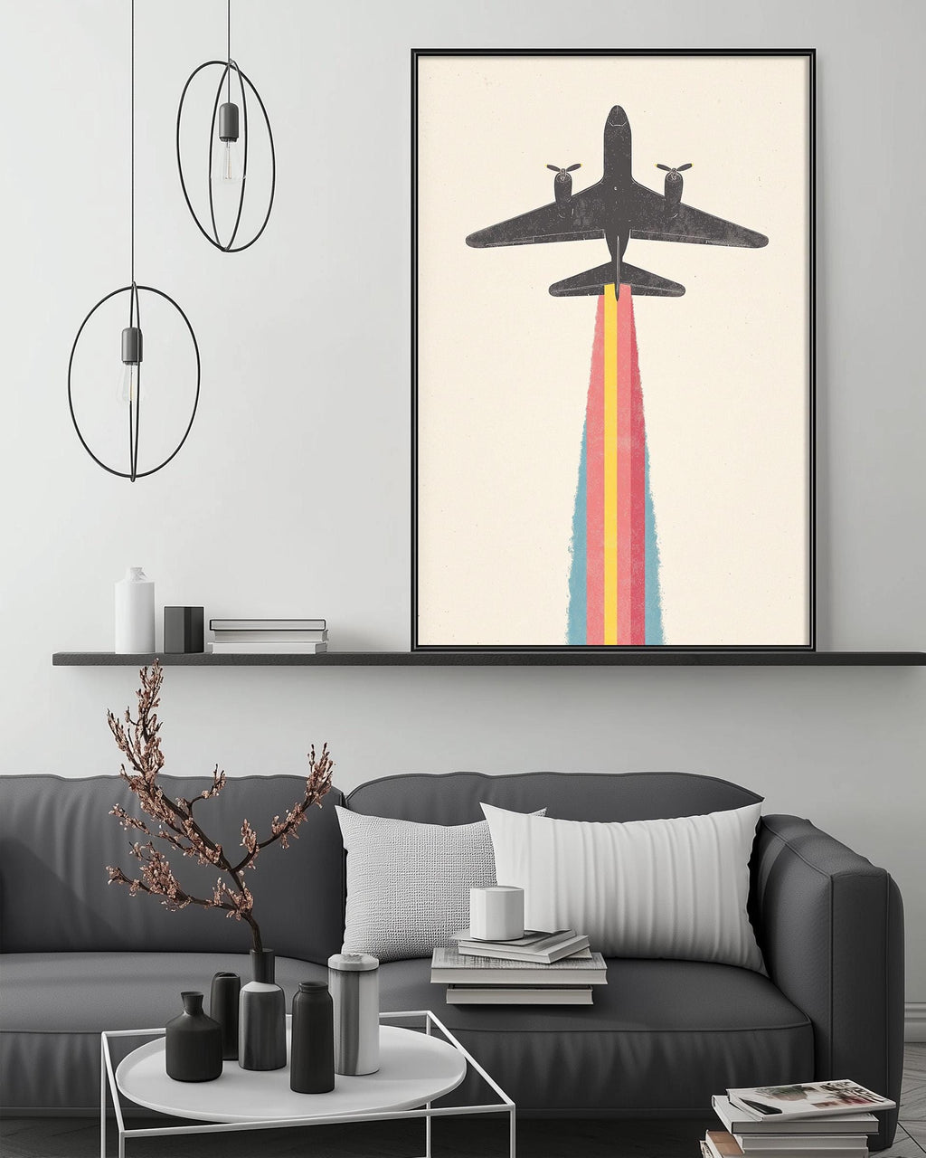 a modern living room with a gray sofa, a coffee table, and a large framed artwork depicting a plane with a colorful smoke trail.