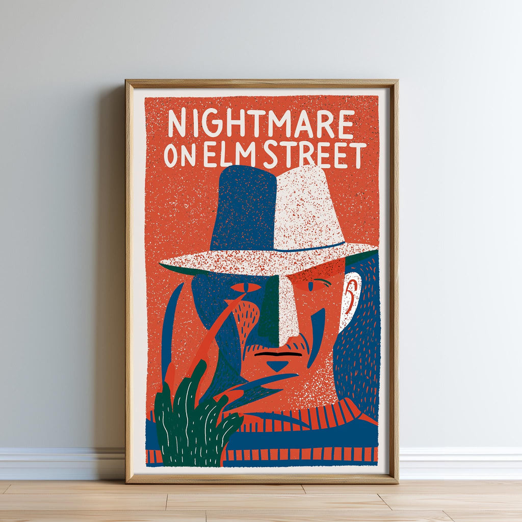 The image is a framed poster featuring an illustration of a man's face wearing a hat, with the text "NIGHTMARE ON ELM STREET" prominently displayed.