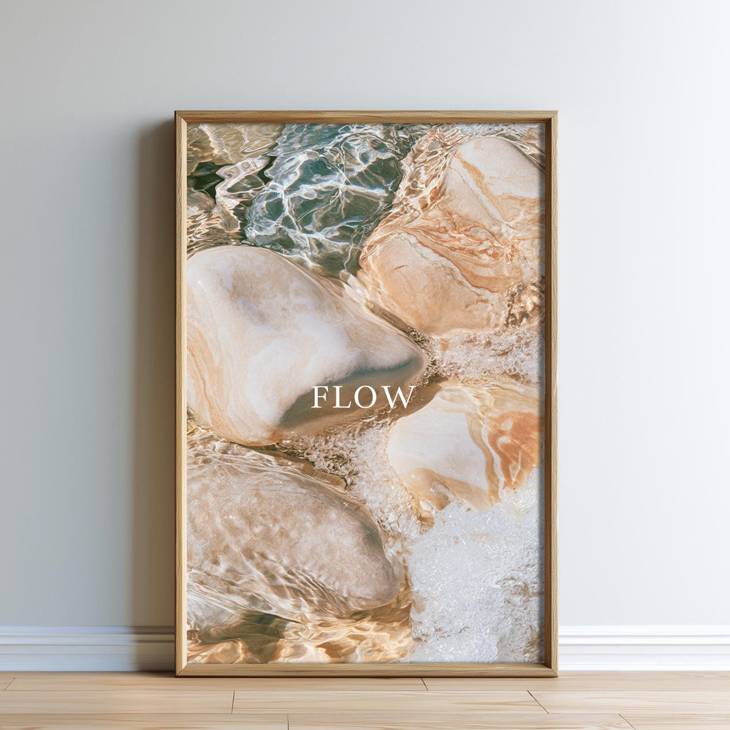 The image is a framed photograph of rocks and water, with the word "FLOW" prominently displayed in the center.