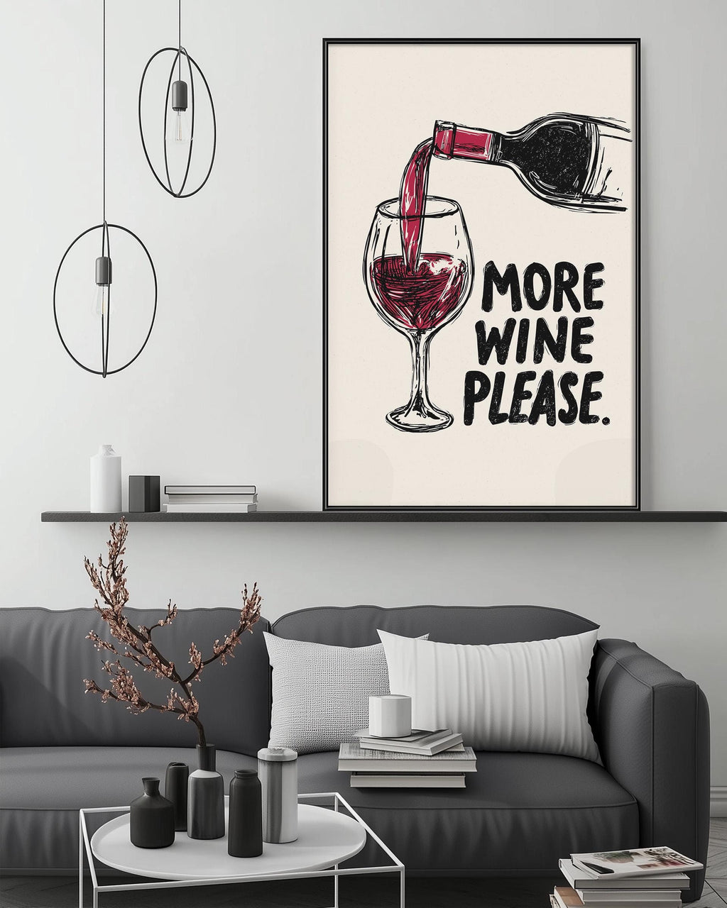 a living room with a gray couch, a coffee table, and a framed poster on the wall that says "MORE WINE PLEASE".