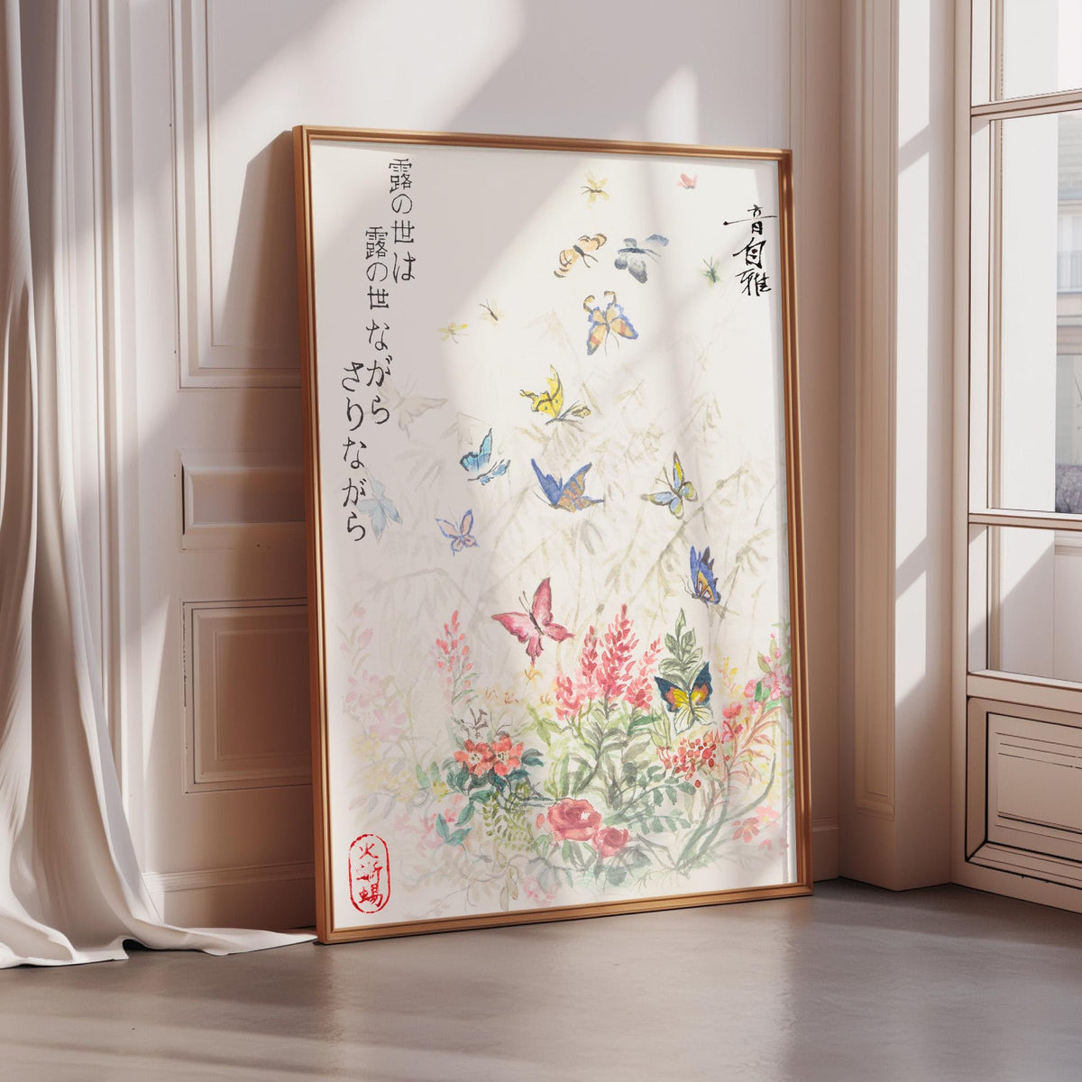 A framed poster with a floral design and butterflies is displayed on a wall in a room with sunlight streaming in through a window.
