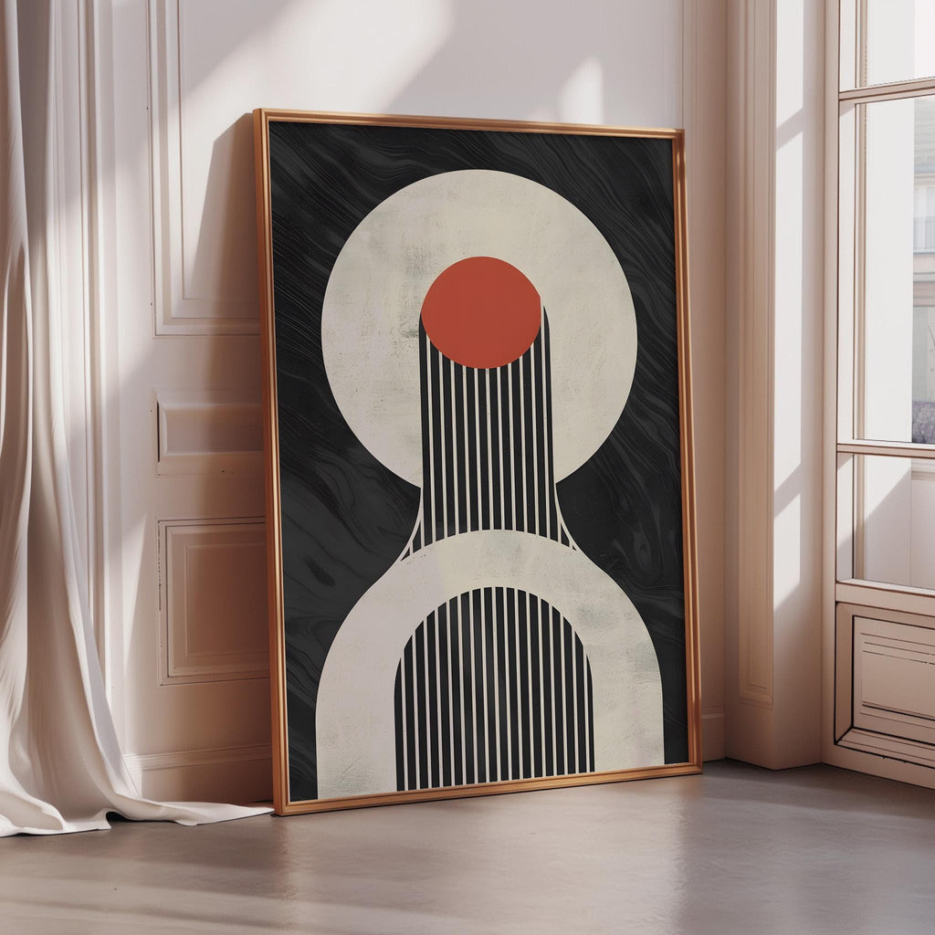 a large abstract art piece with a black and white color scheme, featuring a red circle and a black and white striped pattern. The art piece is displayed on a wall in a room with a window.