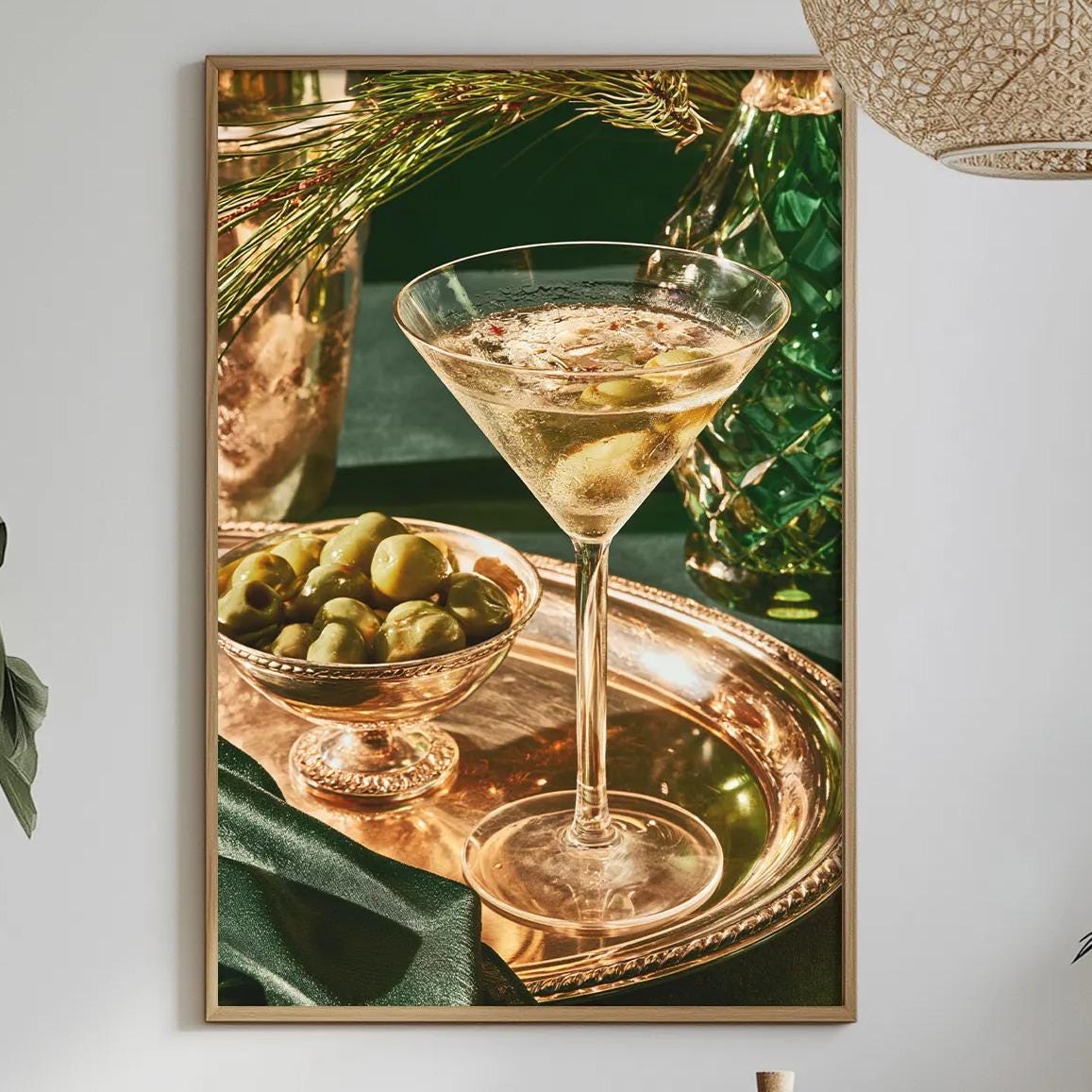 a dining table set with a glass of wine, a bowl of olives, and a bottle of wine, with a framed picture hanging on the wall above the table.