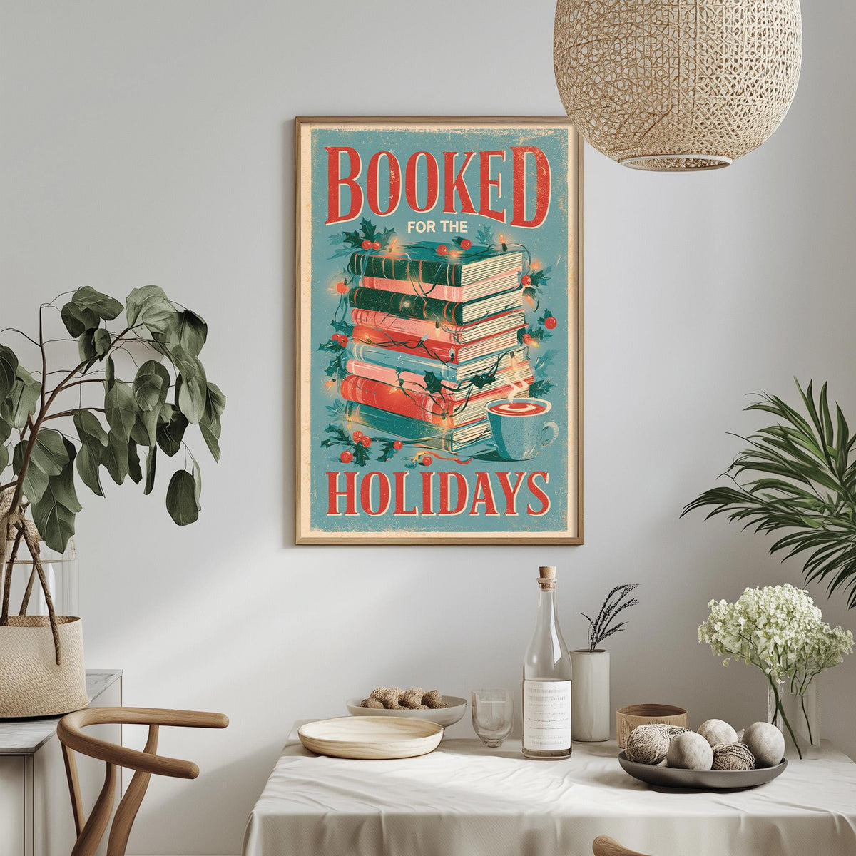 a framed poster with the text "BOOKED FOR THE HOLIDAYS" hanging on a wall above a dining table with various items on it.