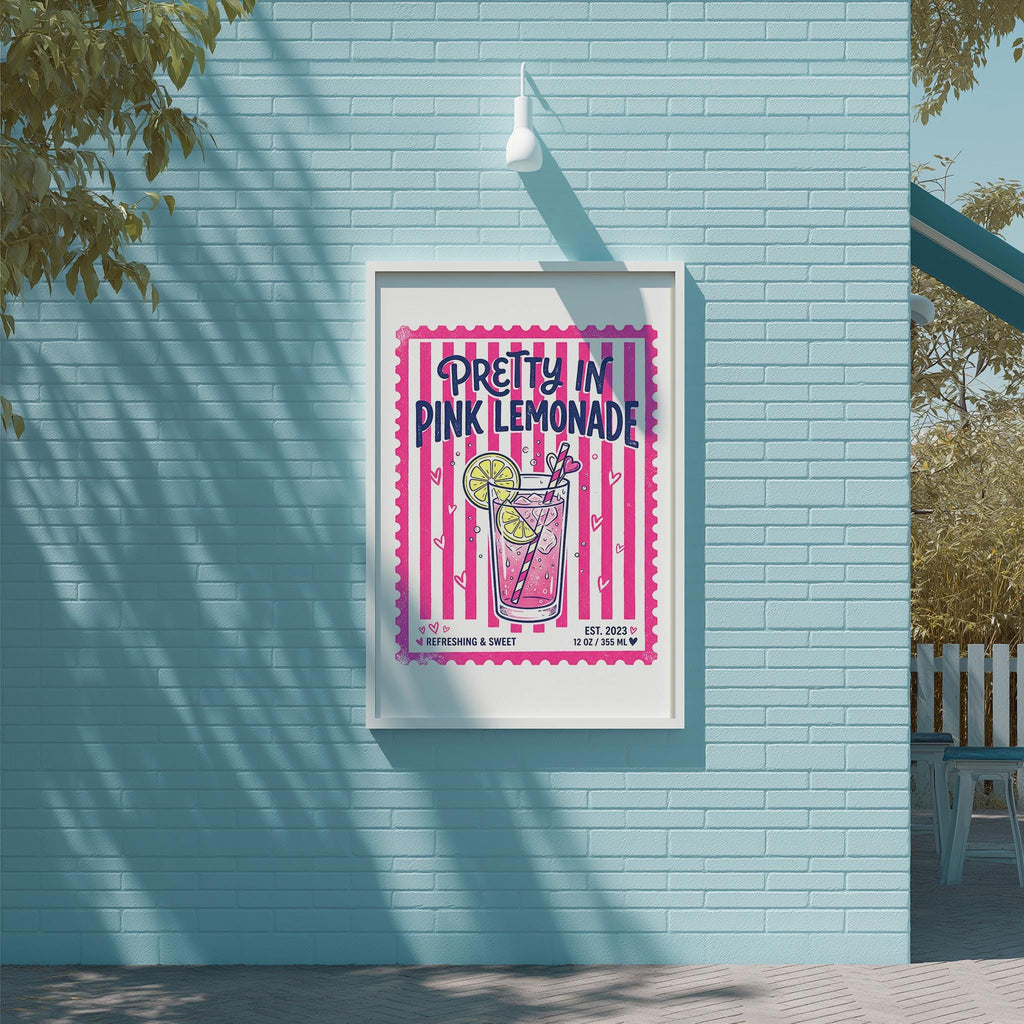 A framed poster advertising "Pretty in Pink Lemonade" is displayed on a light blue brick wall.