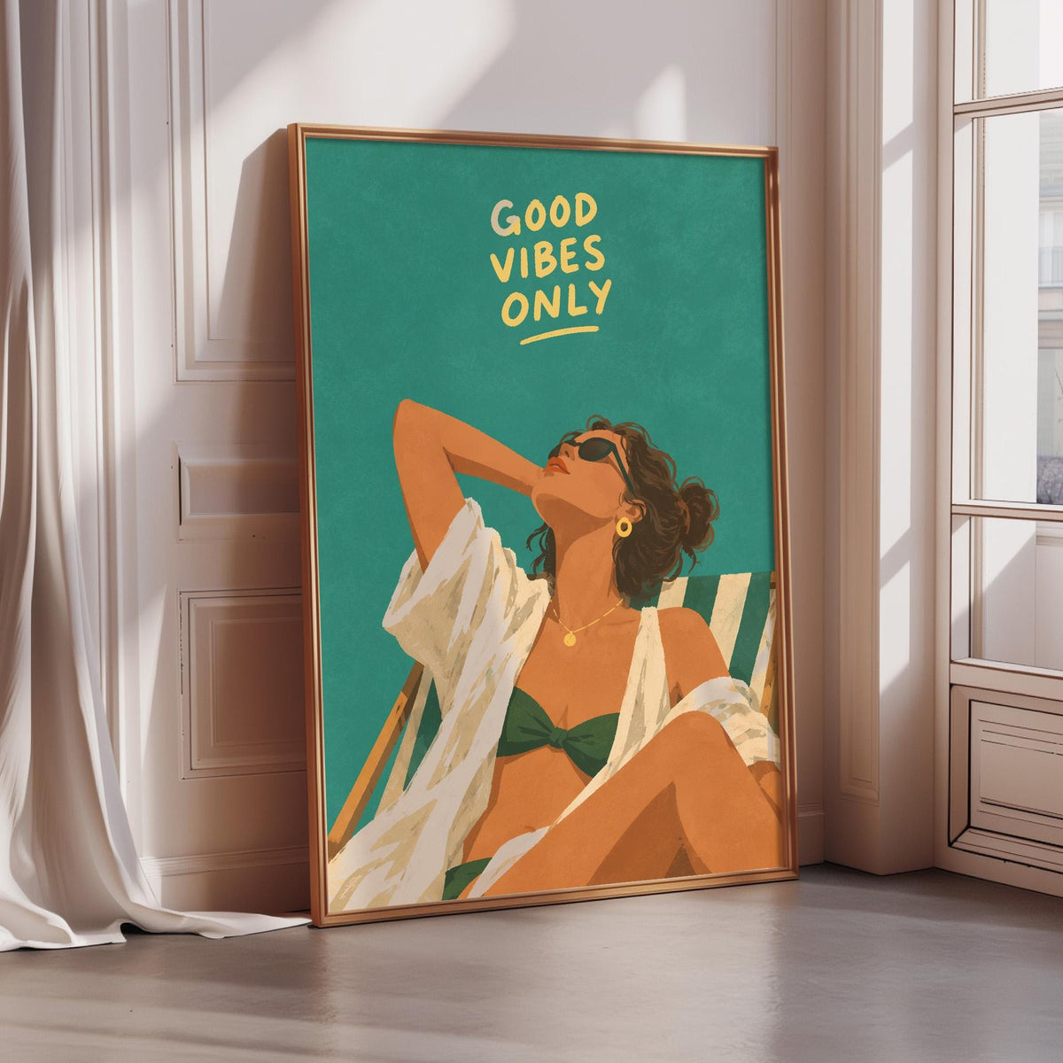 a framed illustration of a woman in a bikini, with the text "GOOD VIBES ONLY" written above her.