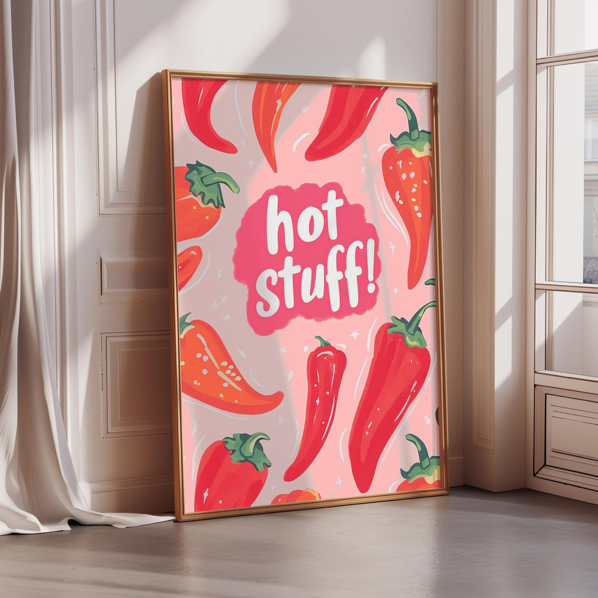 A framed poster with a vibrant design featuring red chili peppers and the text "hot stuff!"