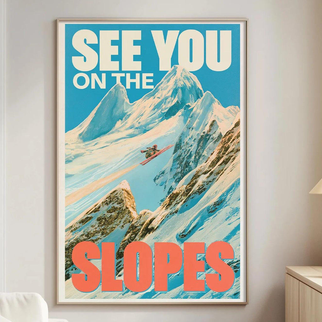 a poster of a mountain landscape with the text "See You on the Slopes" displayed prominently.