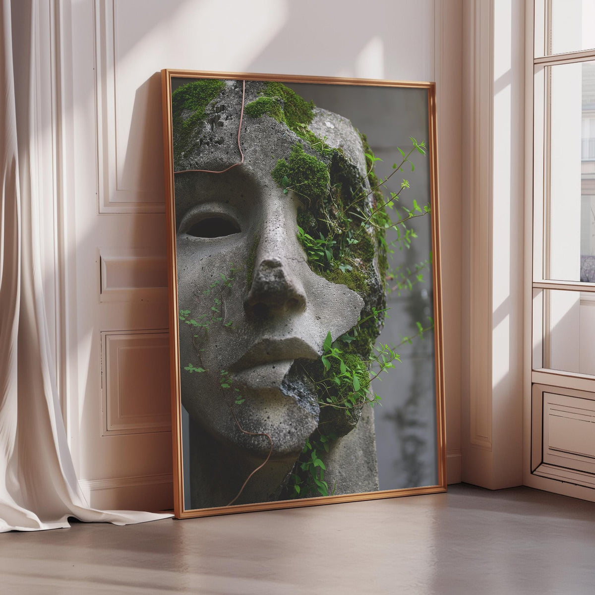 A framed image of a stone statue with moss growing on it, placed on a wooden floor in a room with a window.