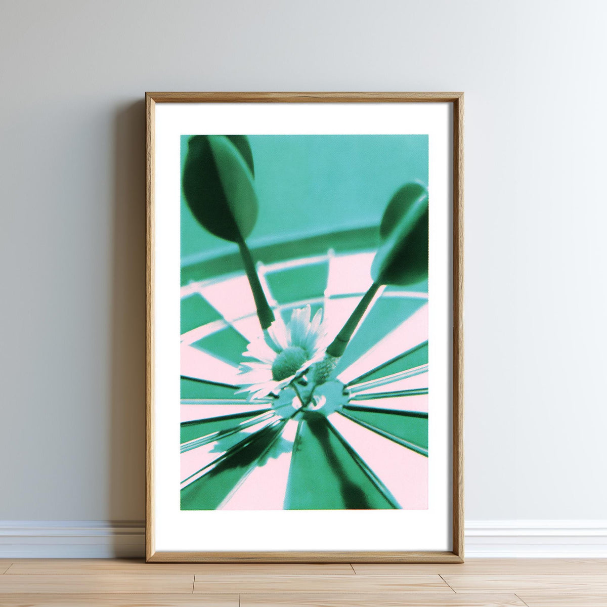 The image is a framed photograph of a flower in a vase, with a green background and a pink and white pattern.