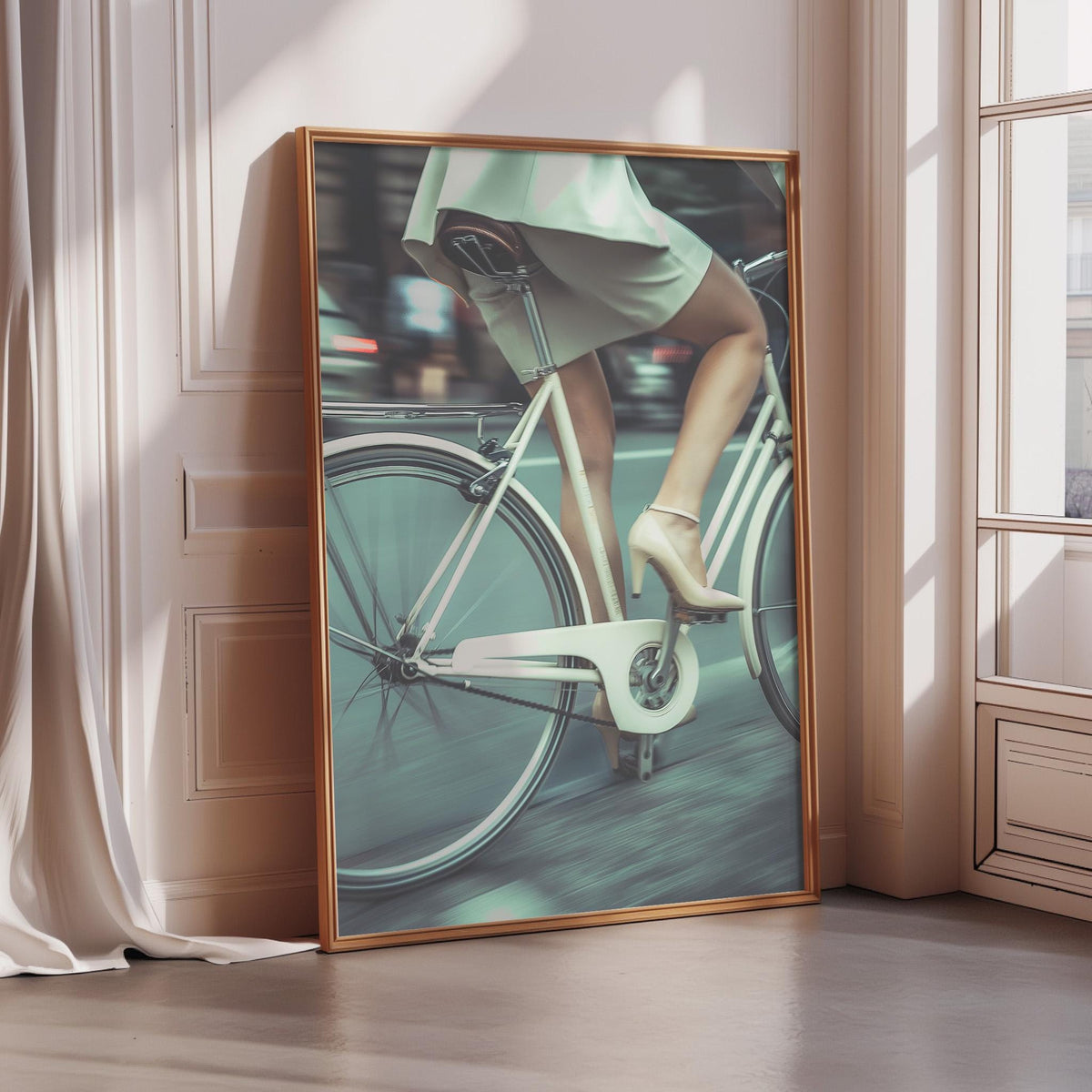 A framed image of a person riding a bicycle, with a focus on the cyclist's legs and the bicycle's frame.
