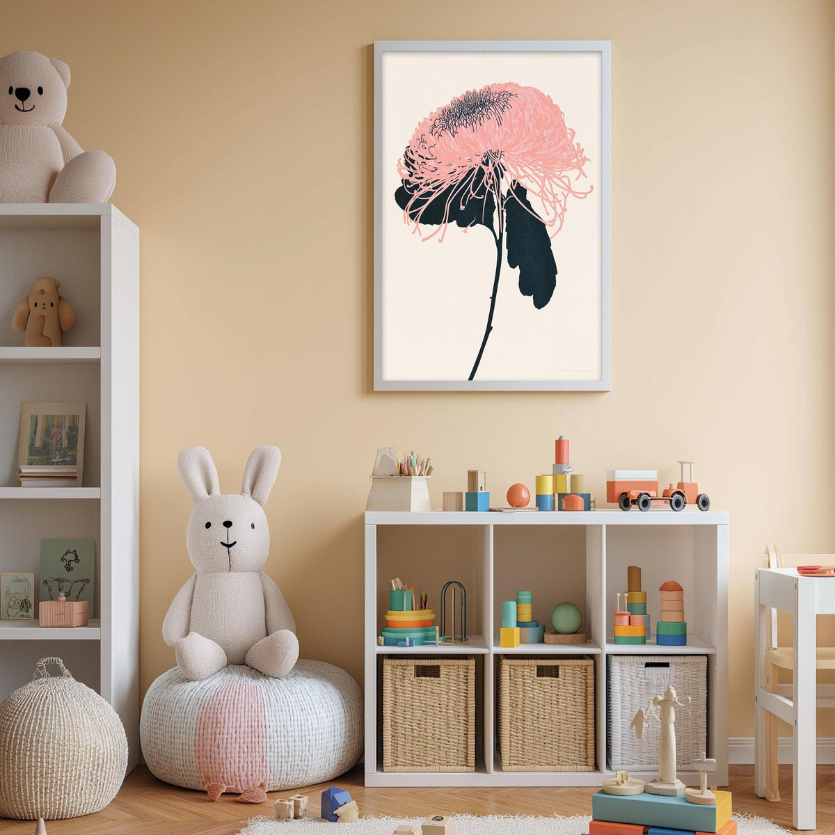 A child's bedroom with a white bookshelf, a stuffed rabbit, a framed flower artwork, and a toy train set.