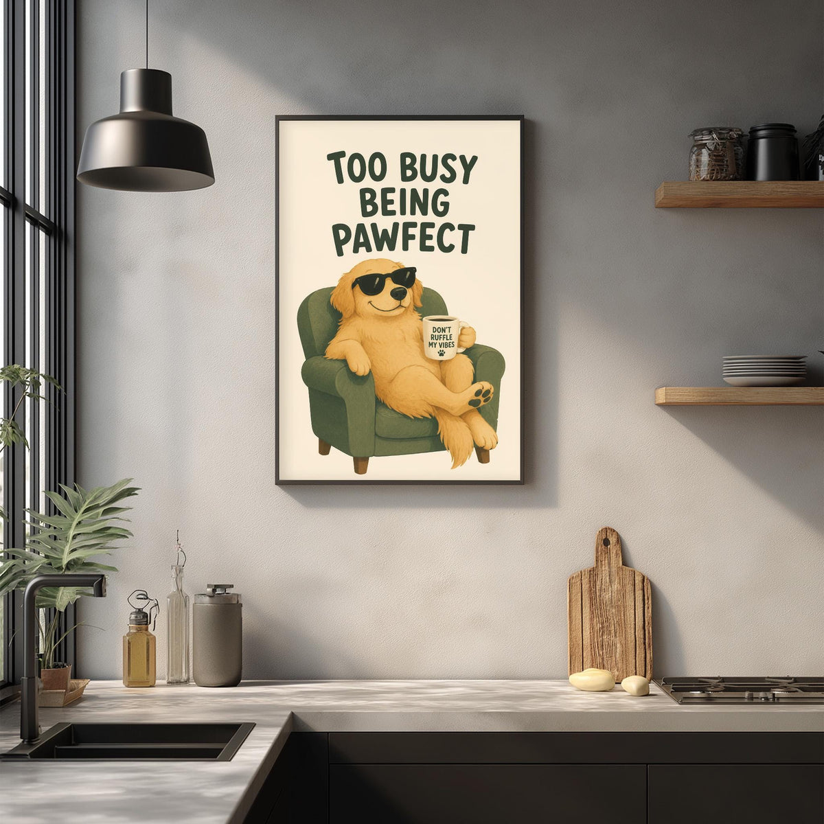 a framed poster of a dog sitting in a chair, with the text "Too busy being pawfect" written above it. The poster is displayed on a wall above a kitchen counter with various kitchen items such as a cutting board, a bottle, and a cup.