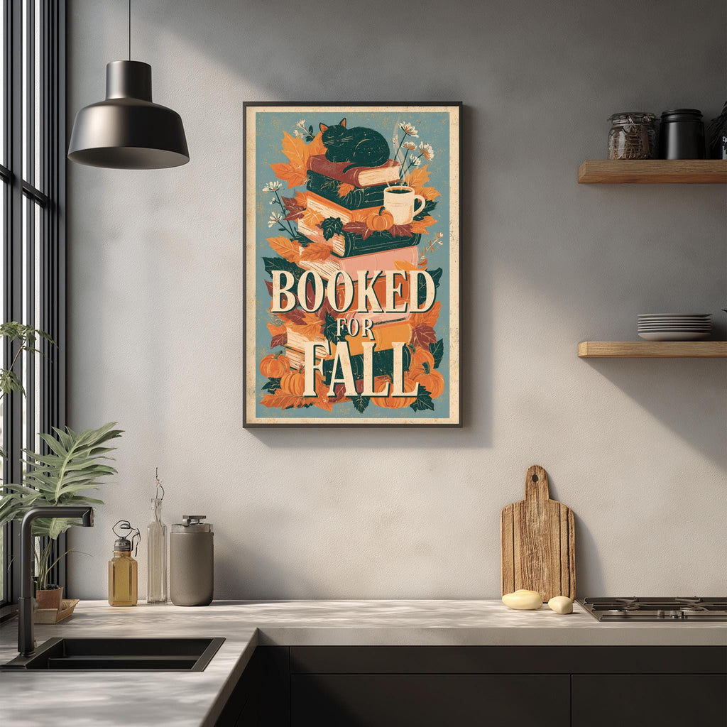 a kitchen counter with various items, including a framed poster with a cat and autumn leaves, a wooden cutting board, and a potted plant.