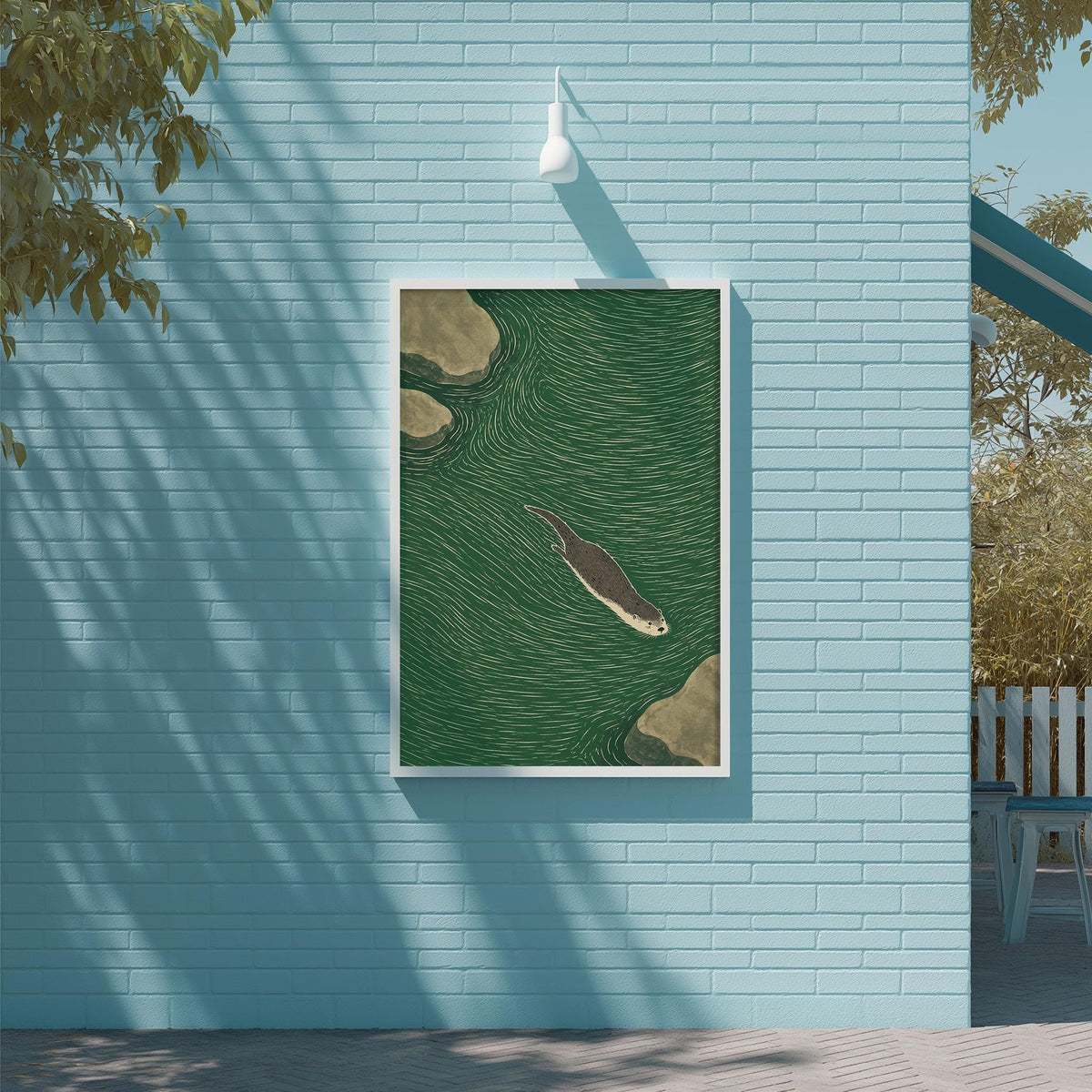 a blue wall with a framed illustration of a seal swimming in the water, which is mounted on the wall.