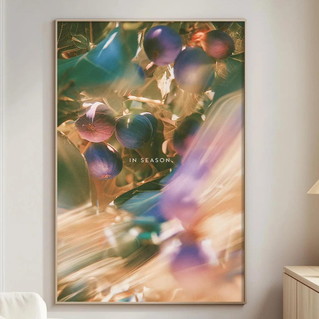 a large, colorful painting of berries hanging on a wall in a living room.