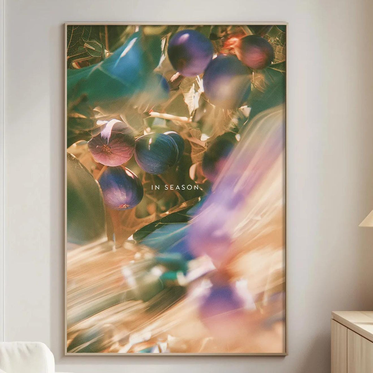 a large, colorful painting of berries hanging on a wall in a living room.