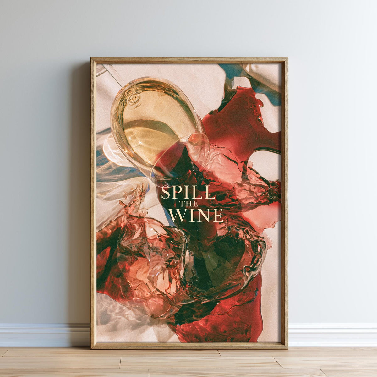 The image is a framed poster with a vibrant abstract design featuring splashes of red and green colors, along with the text "SPILL THE WINE" prominently displayed.