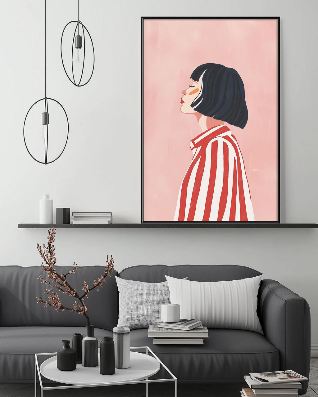 a modern living room with a gray sofa, a coffee table, and a large framed illustration of a woman with short hair wearing a red and white striped shirt. The room has a minimalist and stylish design, with a pink wall and pendant lights hanging above the sofa.