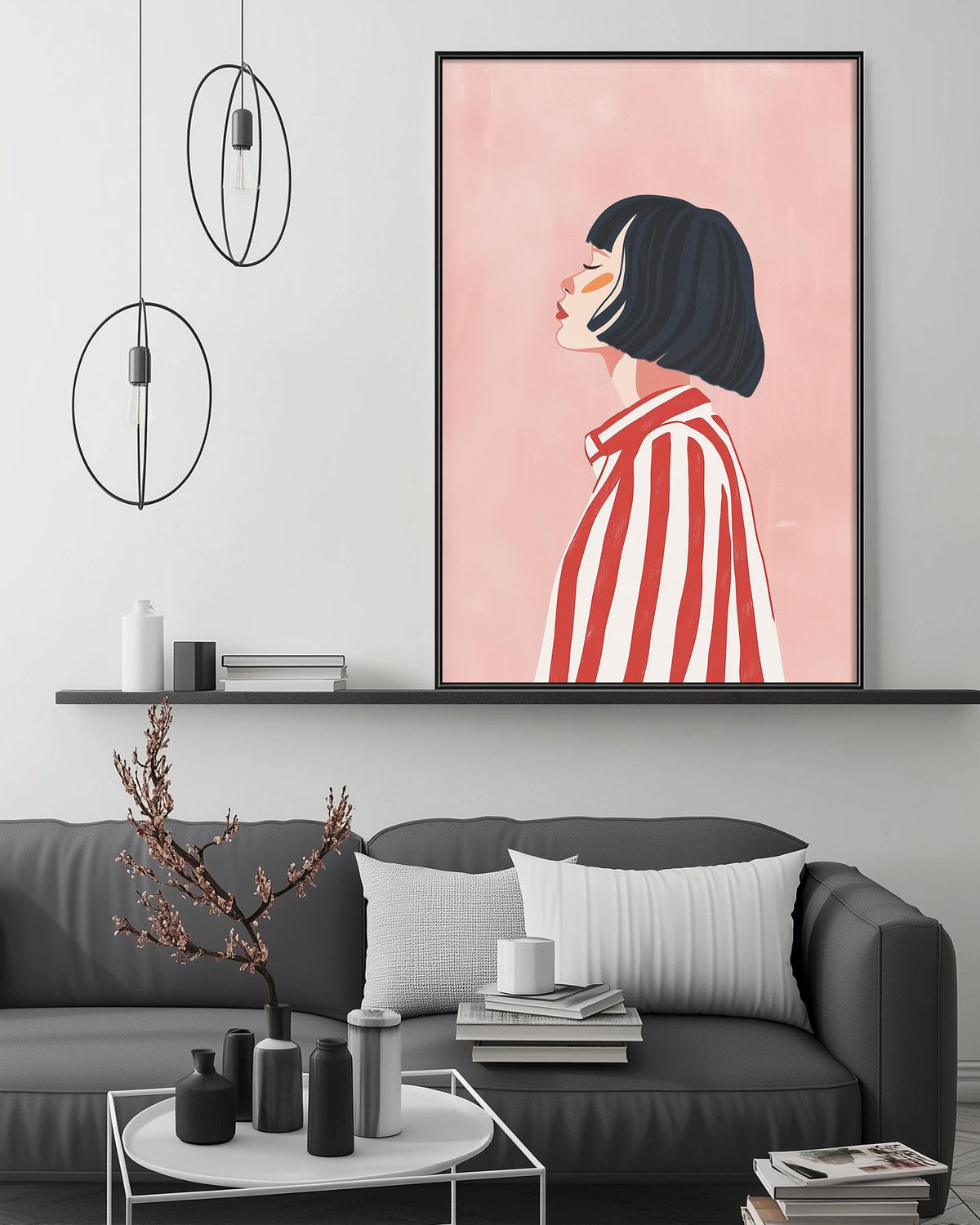 a modern living room with a gray sofa, a coffee table, and a large framed illustration of a woman with short hair wearing a red and white striped shirt. The room has a minimalist and stylish design, with a pink wall and pendant lights hanging above the sofa.