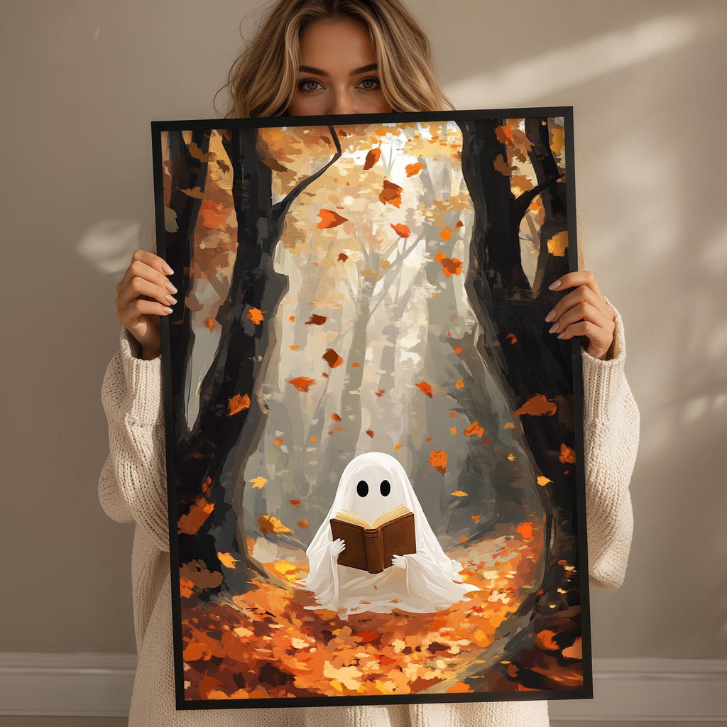 A woman holds up a framed artwork depicting a ghost reading a book in a forest with falling leaves.