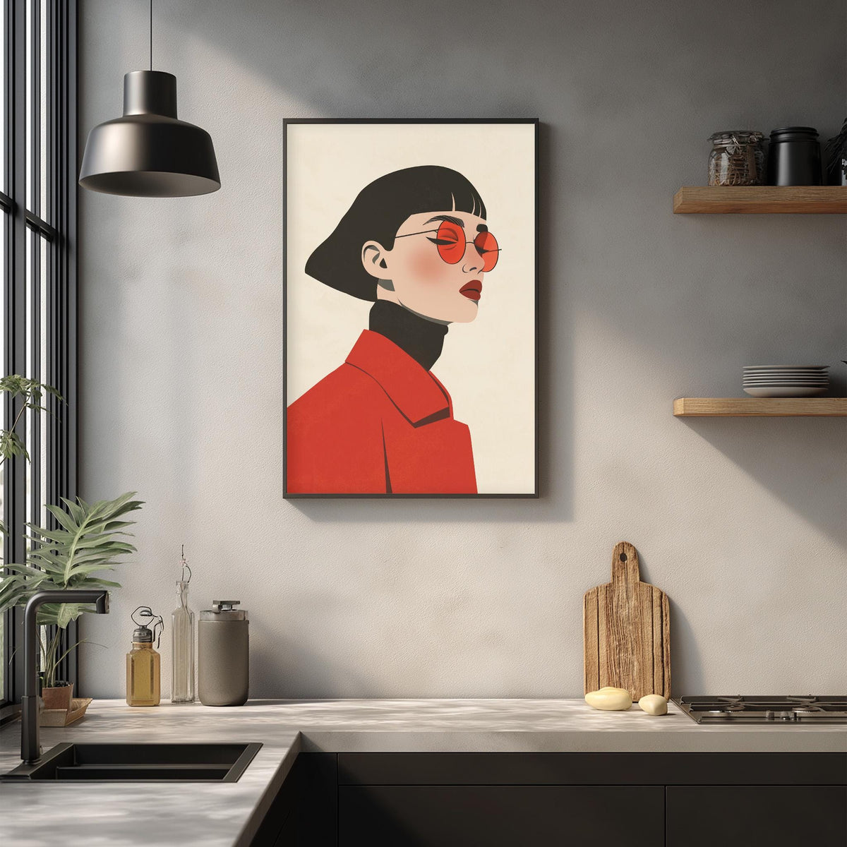 a framed illustration of a woman wearing a red jacket and sunglasses, hanging on a wall above a kitchen counter with various kitchen items and decor.