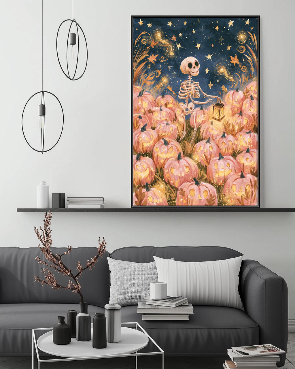 a cozy living room with a gray sofa, a coffee table, and a large framed artwork depicting a skeleton surrounded by a field of pumpkins against a starry night sky.