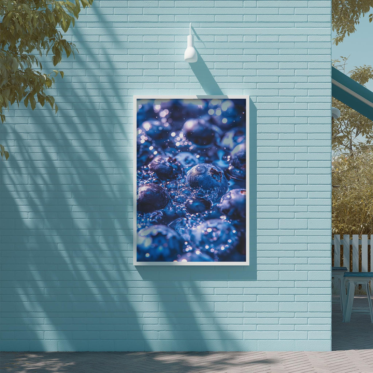 a blue brick wall with a framed photograph of blueberries hanging on it.