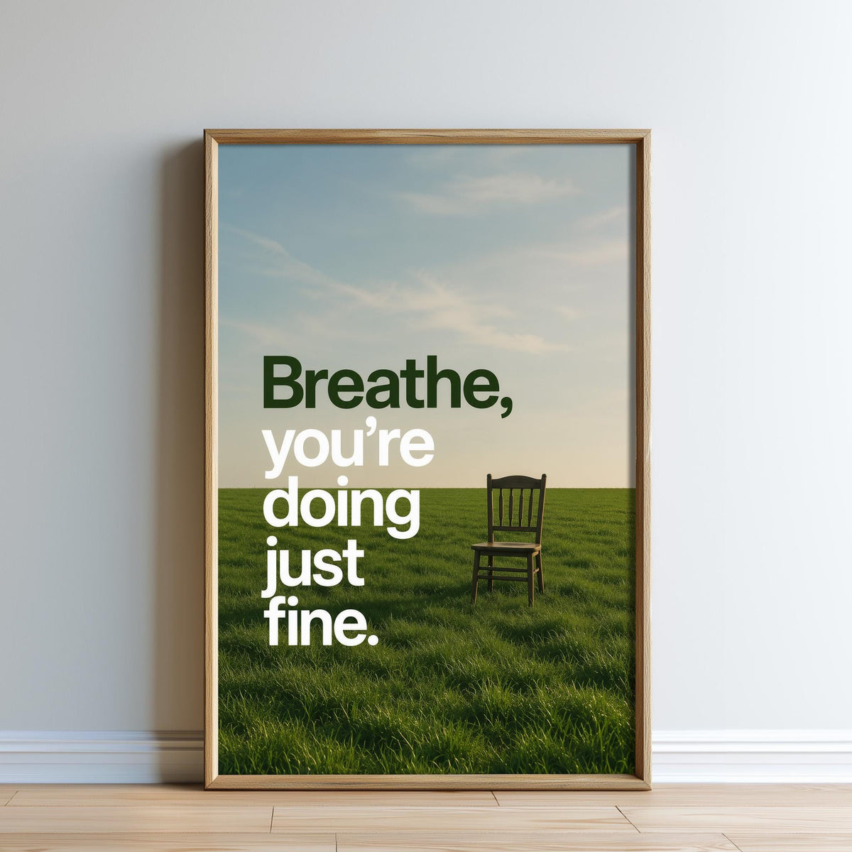 a wooden chair in a grassy field with a blue sky in the background.