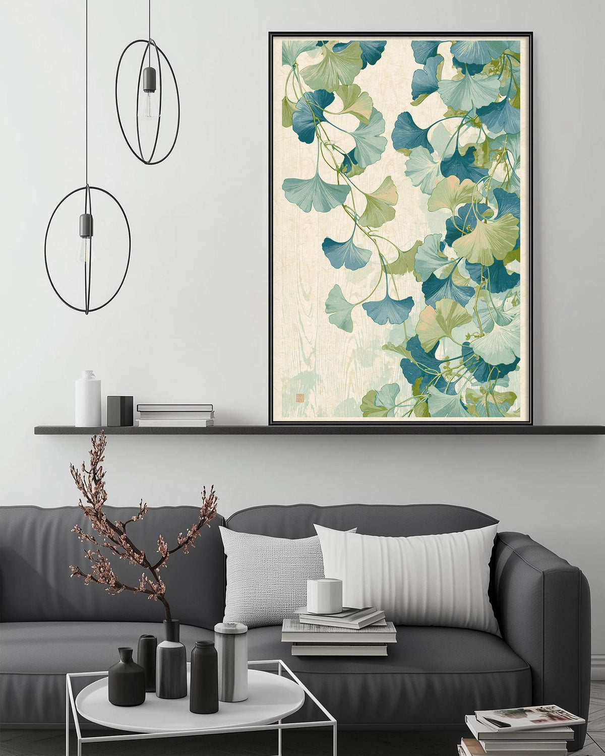 a modern living room with a gray sofa, a coffee table, and a large framed print of a floral design on the wall above the sofa.