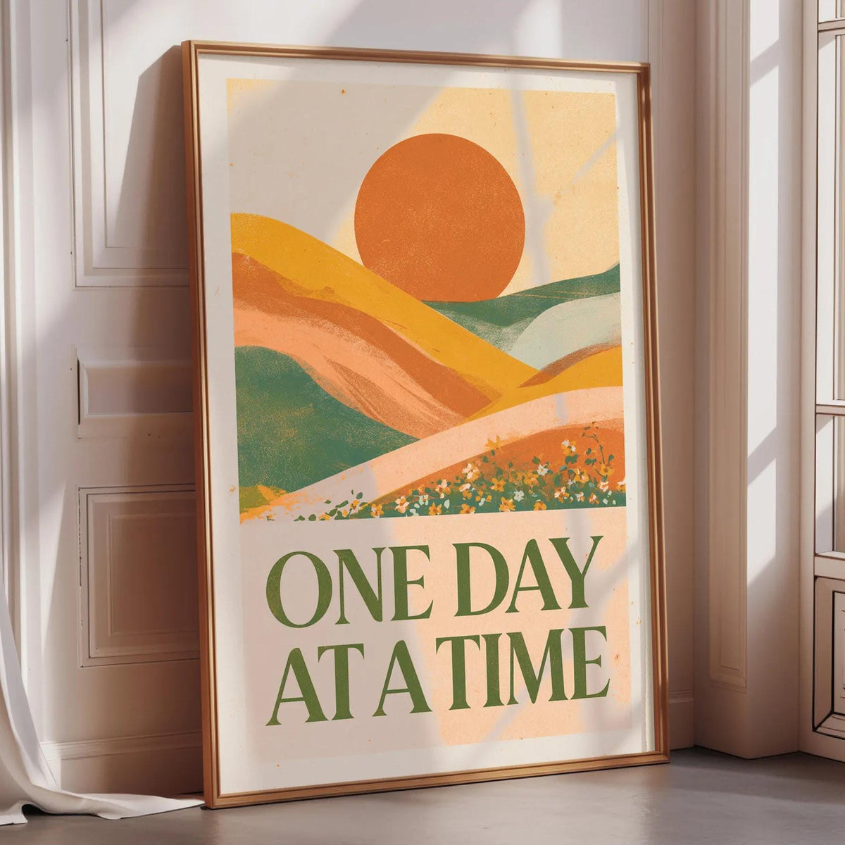 a framed poster with a vibrant, abstract landscape design and the text "ONE DAY AT A TIME" displayed prominently on it.