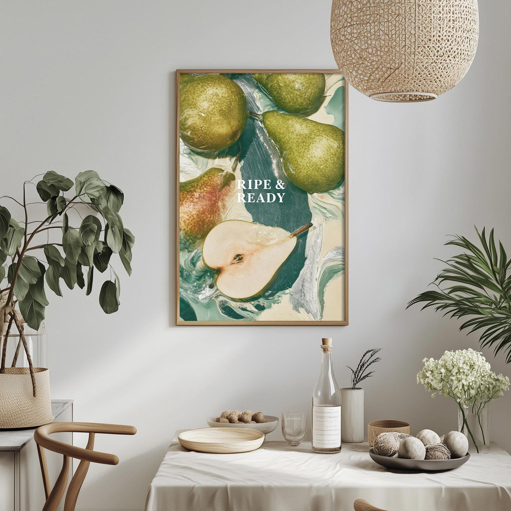 a dining table with a white tablecloth, a bowl of fruit, a bottle, and a vase with flowers. Above the table, there is a framed picture of pears with the text "Ripe & Ready" written on it.