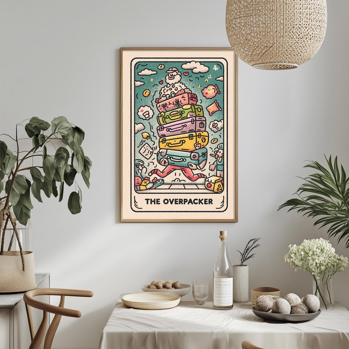 a framed illustration of a colorful, whimsical scene with various objects and characters, including a suitcase, a bird, and a person. The text "THE OVERPACKER" is prominently displayed, indicating the title of the artwork.