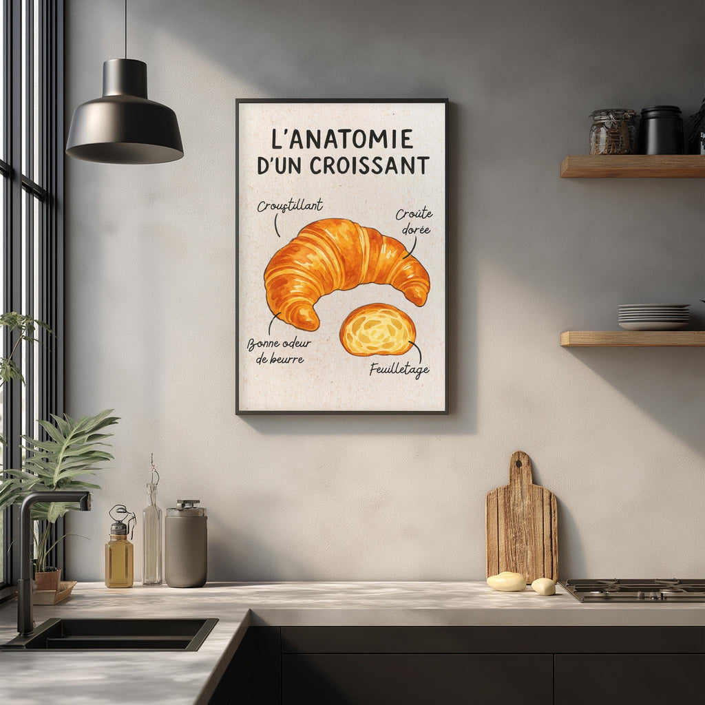 a framed illustration of a croissant hanging on a wall in a kitchen.