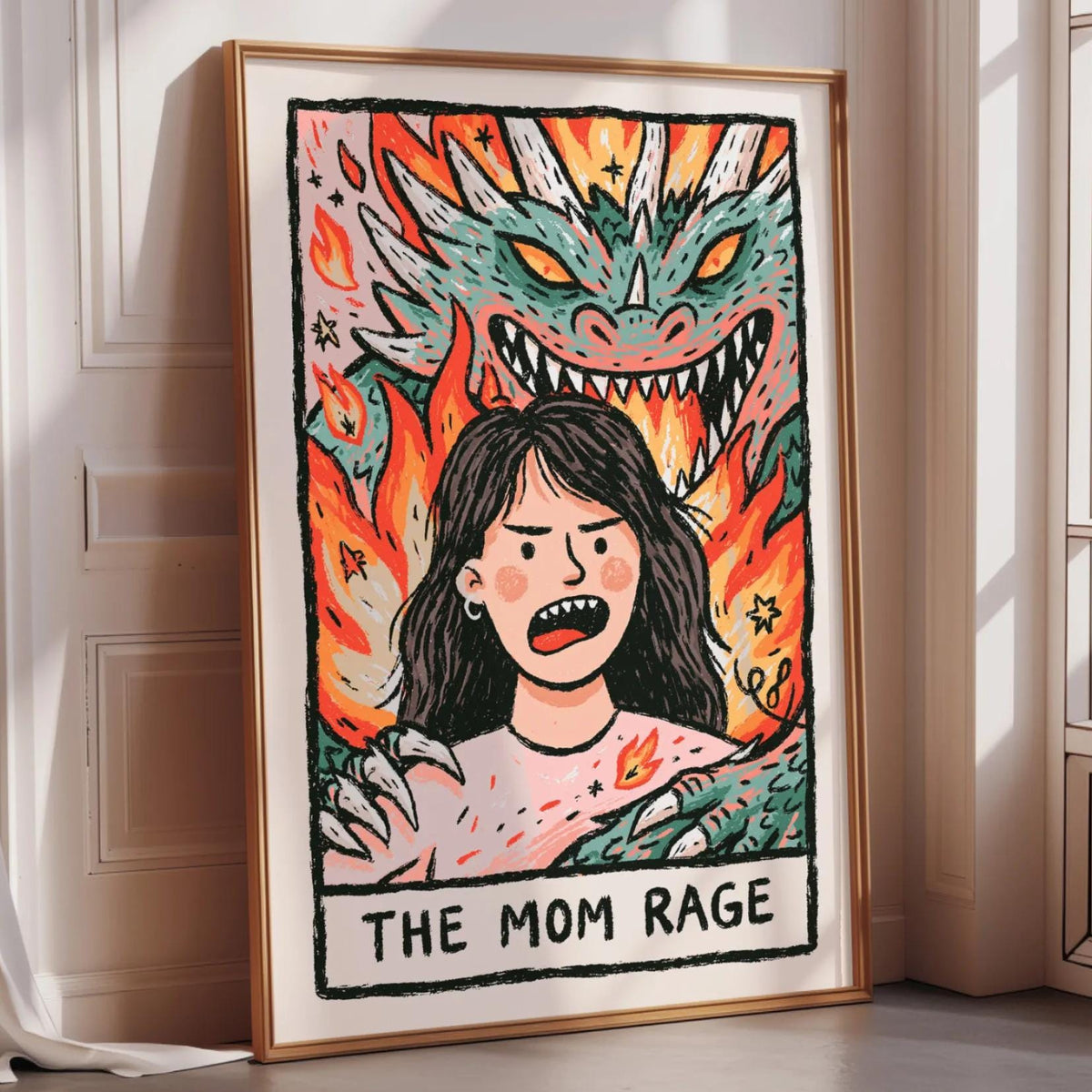 The image is a framed artwork depicting a woman with a dragon behind her, and the text "THE MOM RAGE" is written below the illustration.