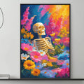 a large, colorful painting of a skeleton surrounded by flowers and plants, hanging on a wall above a gray couch in a living room setting.